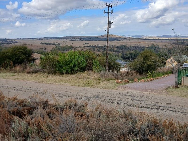A wide-angle view of the surrounding landscape and rural terrain, featuring an existing utility pole and overhead power lines.
