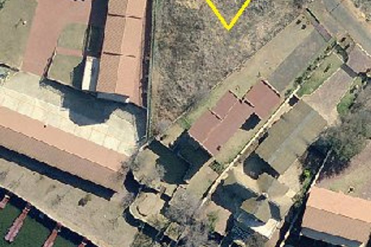 Aerial view of a vacant residential plot situated in a waterfront estate, highlighting the land parcel and surrounding neighborhood layout.