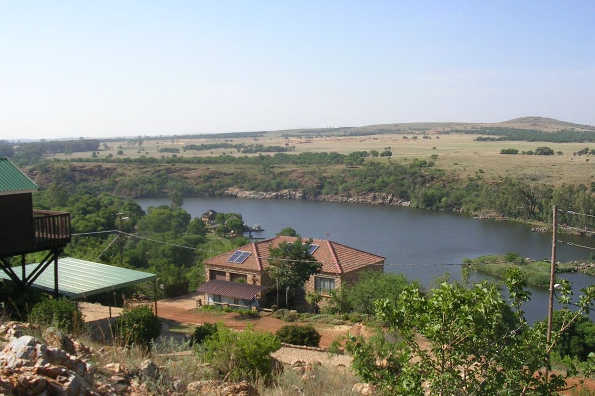 Elevated scenic view overlooking a river and surrounding natural landscape with residential properties visible in the distance.