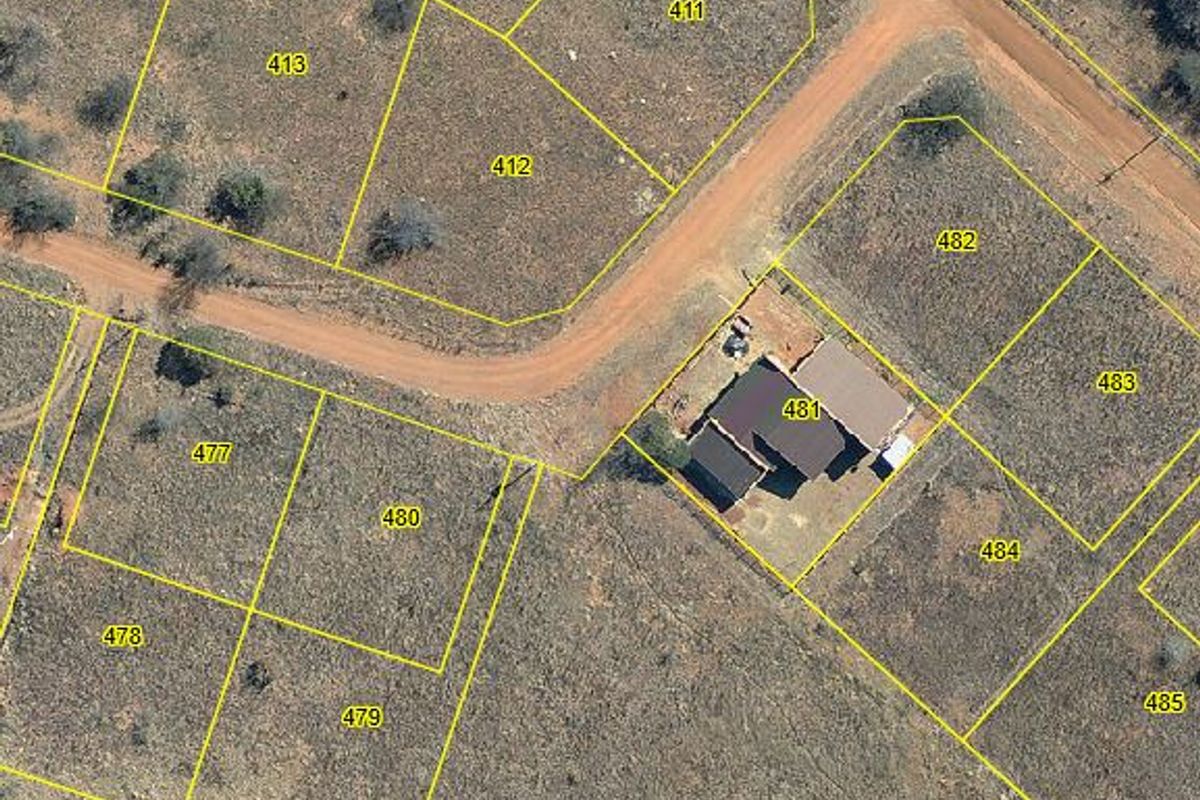 Aerial view of residential vacant land plots with clearly marked boundaries and dirt road access in a rural setting.