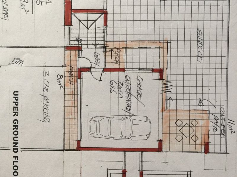 Hand-drawn architectural floor plan for the upper ground floor, detailing the garage, entertainment area, porch, sundeck, and covered patio layout.