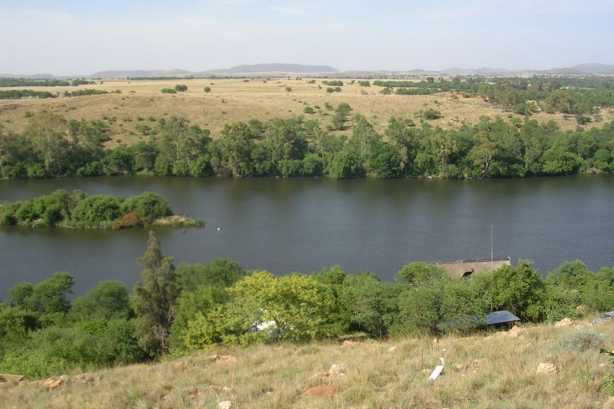 A scenic elevated view overlooking a river and natural landscape, showcasing the tranquil surroundings of the vacant land property.