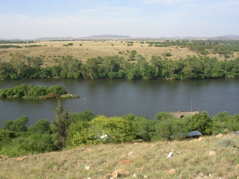 A scenic elevated view overlooking a river and natural landscape, showcasing the tranquil surroundings of the vacant land property.