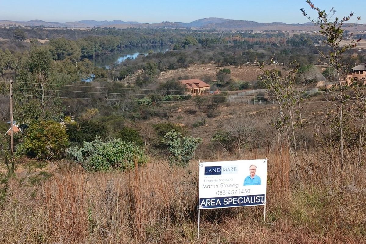 A scenic elevated view overlooking a natural landscape with a river, showcasing the surrounding terrain and vegetation.
