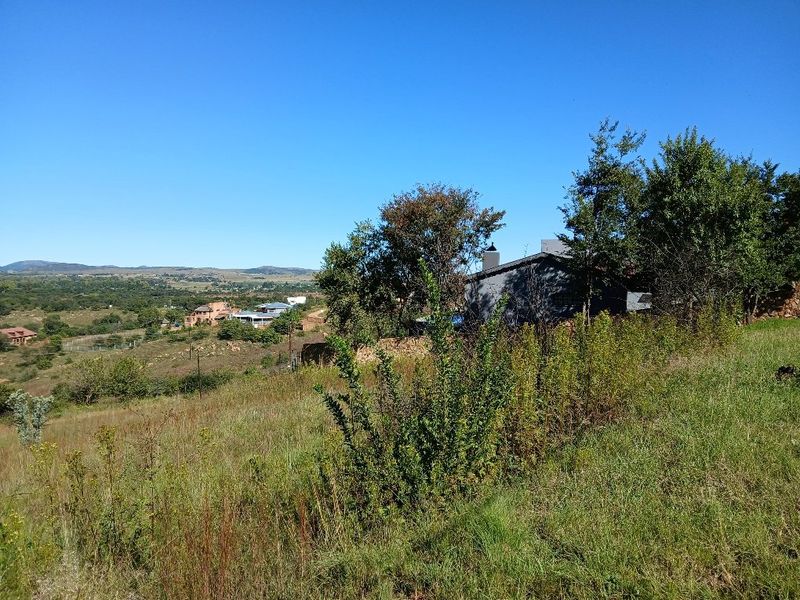 A scenic view of the surrounding landscape and neighboring properties from the vacant residential land.