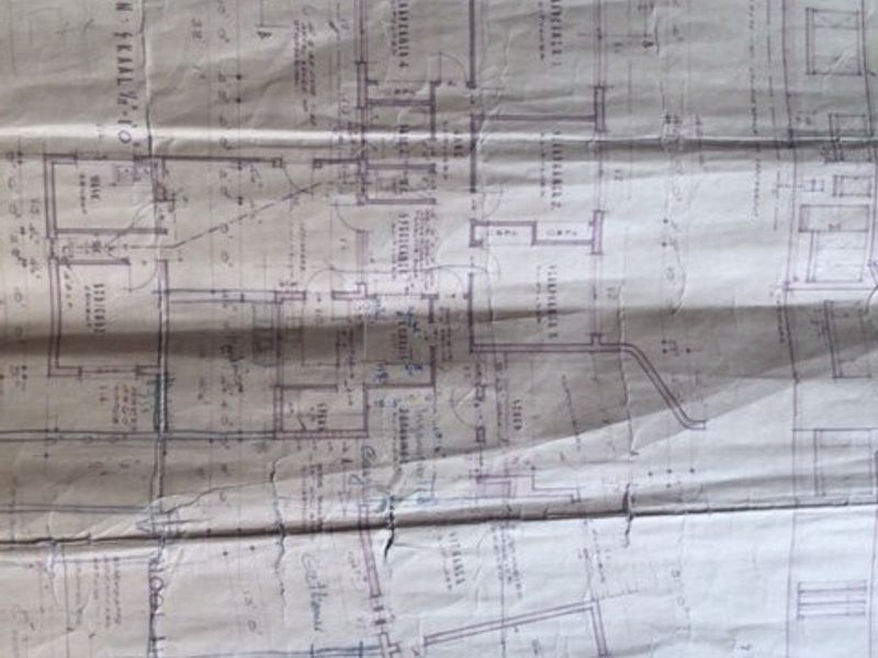 A physical paper copy of the property floor plan showing the layout and architectural design.