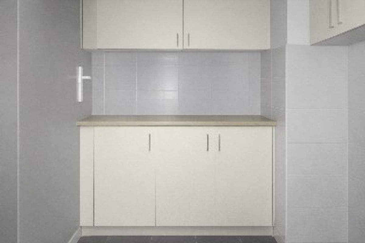 A clean and functional kitchen area featuring neutral built-in cabinetry, a tiled splashback, and a laminate countertop.
