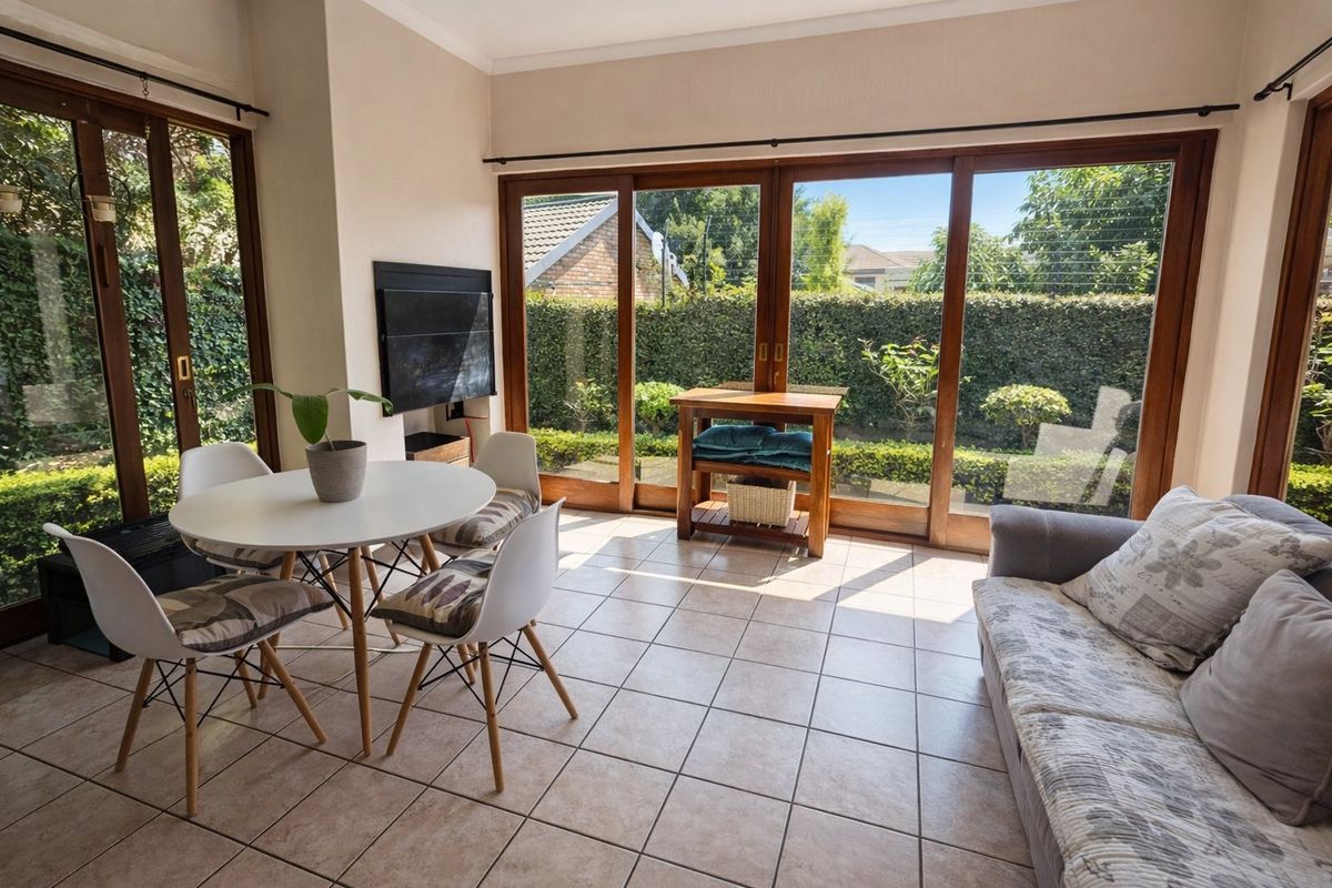 Bright living area featuring large sliding glass doors that provide ample natural light and direct access to the garden.