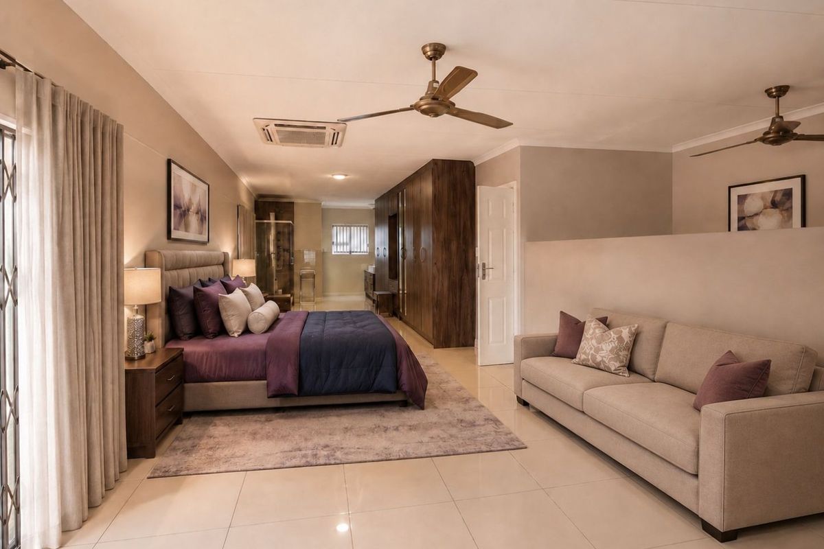 Spacious bedroom featuring tiled flooring, built-in cupboards, ceiling fans, and integrated air conditioning, with an open-plan layout and direct access to outdoor space.