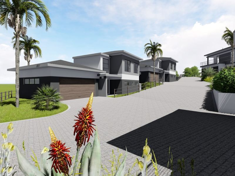 A modern residential development featuring contemporary multi-level homes with paved driveways and integrated garages in a landscaped estate setting.