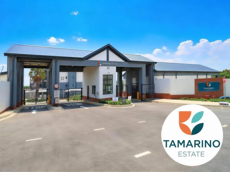 The main entrance and security gatehouse of Tamarino Estate, featuring modern architectural design, paved driveway, and secure access control infrastructure.