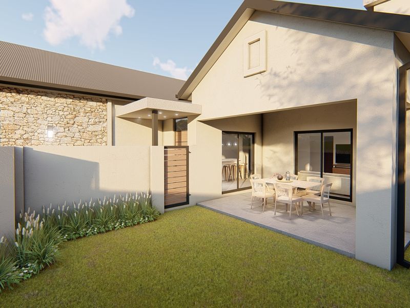 A modern rear exterior view featuring a covered patio, stone-clad wall accents, and a well-maintained garden area with sliding door access.
