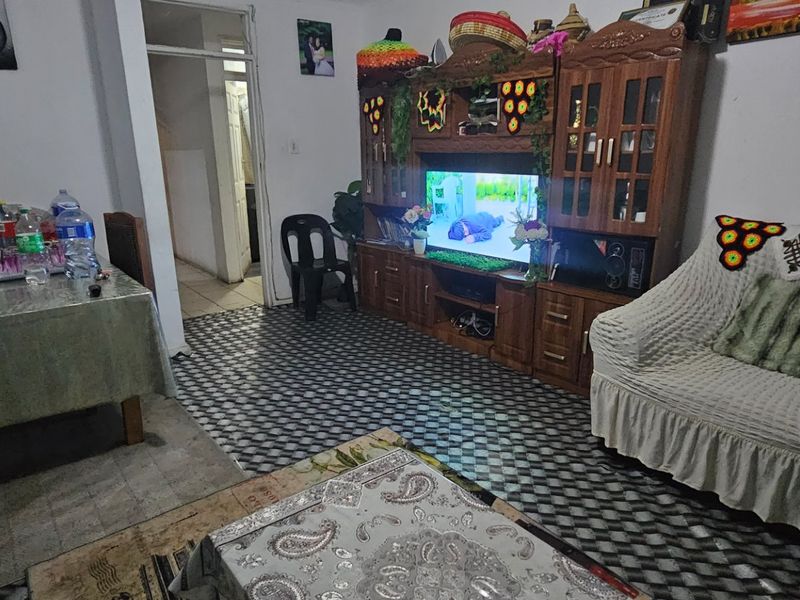 Open plan living and dining area featuring tiled flooring, providing a functional space for daily living and entertaining.