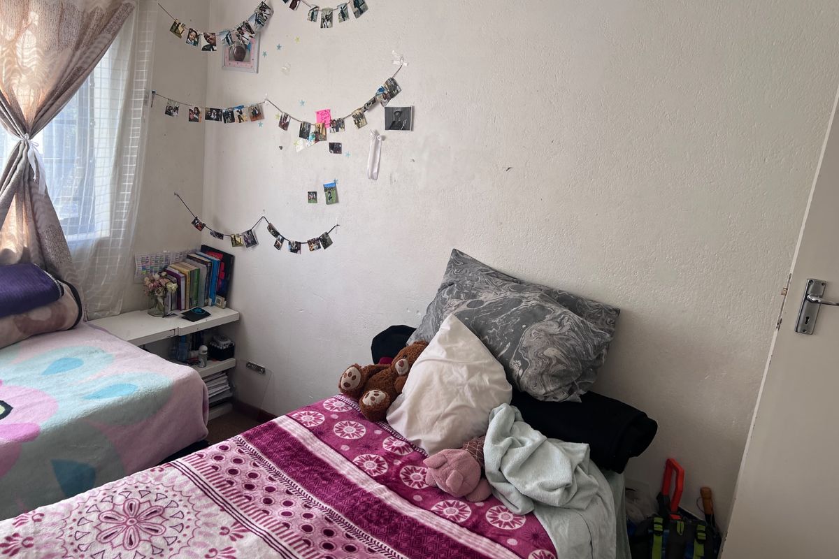 A bedroom featuring standard finishes, requiring minor cosmetic updates such as wall repairs and fresh paint to improve the overall aesthetic.