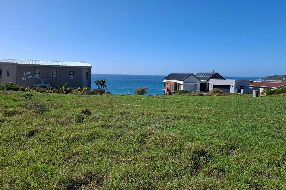 A scenic view of the coastal landscape and ocean from the vacant residential property, showcasing the surrounding neighborhood and sea horizon.