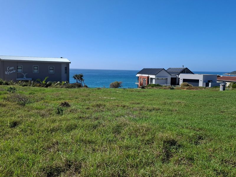 A scenic view of the coastal landscape and ocean from the vacant residential property, showcasing the surrounding neighborhood and sea horizon.