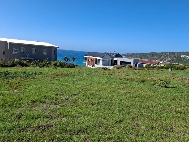 A scenic view of the coastal landscape and ocean from the vacant residential land, showcasing the surrounding neighborhood and natural environment.