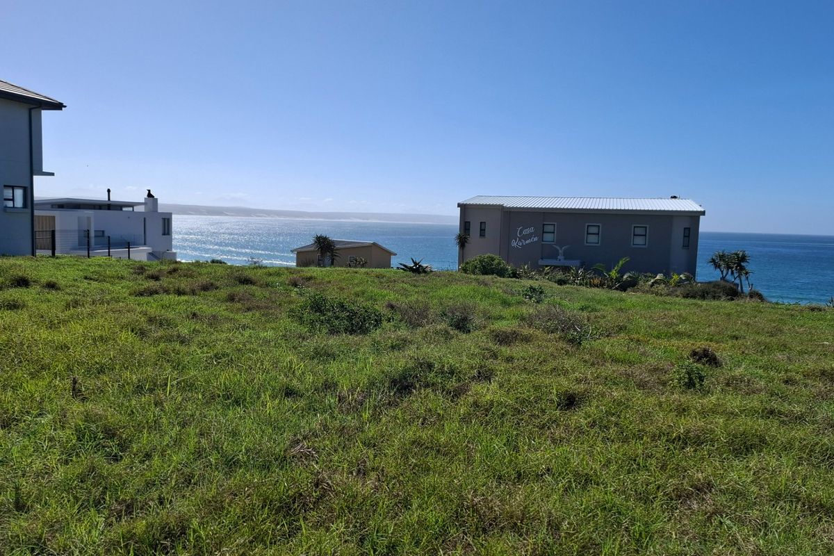 A scenic view of the ocean and surrounding coastal landscape from the vacant residential property.