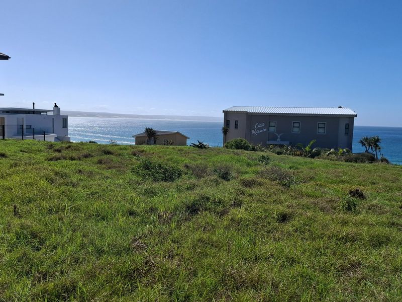 A scenic view of the ocean and surrounding coastal landscape from the vacant residential property.