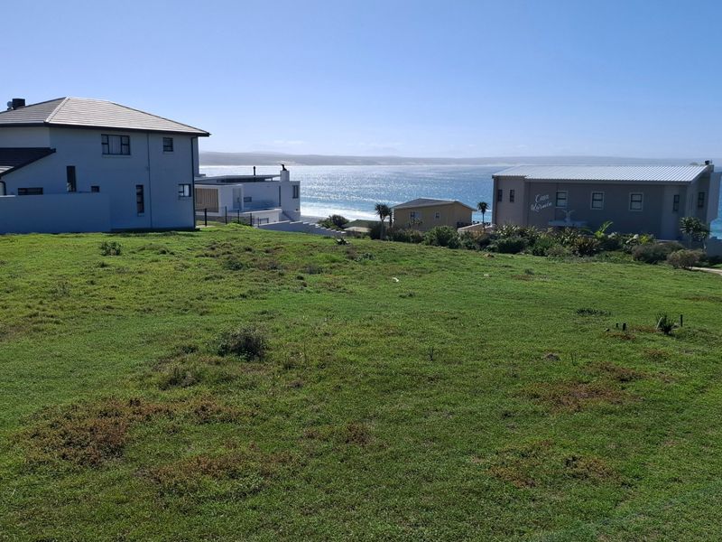 A vacant residential plot offering expansive ocean views and a coastal outlook, situated in a developed neighbourhood.