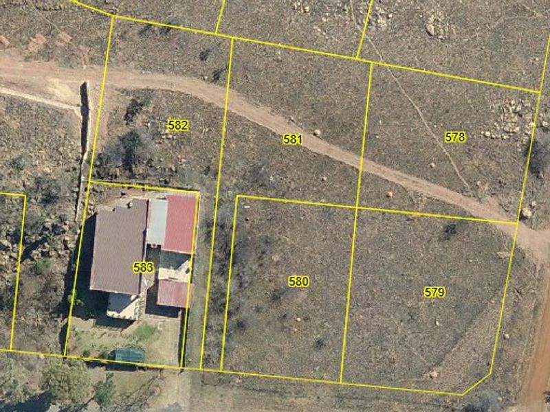 Aerial view of residential land parcels with cadastral boundary overlays, showing vacant plots and an existing dwelling on the adjacent property.