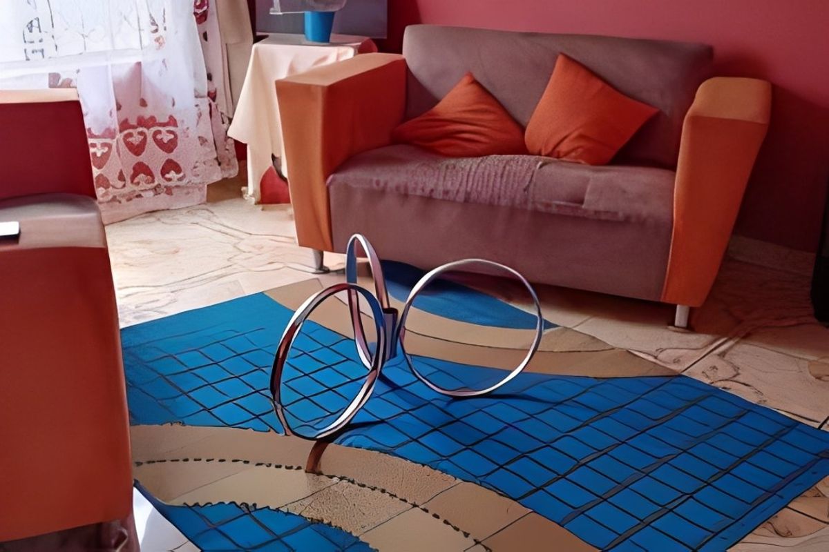 A living room area featuring tiled flooring and red wall paint.