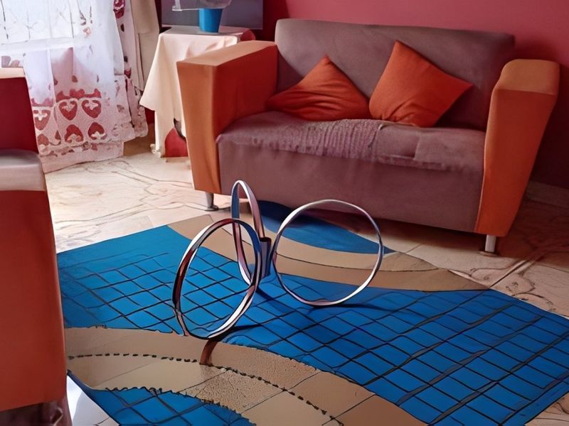 A living room area featuring tiled flooring and red wall paint.