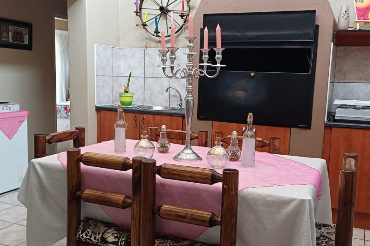 A functional kitchen area featuring built-in wooden cabinetry, tiled backsplash, and a built-in oven, providing a practical space for meal preparation.