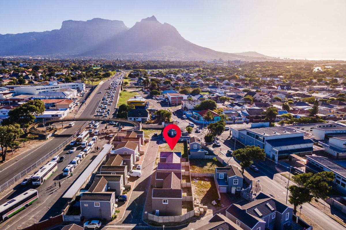 Aerial view of the property location in a suburban neighborhood, featuring proximity to major transport routes and scenic mountain views.