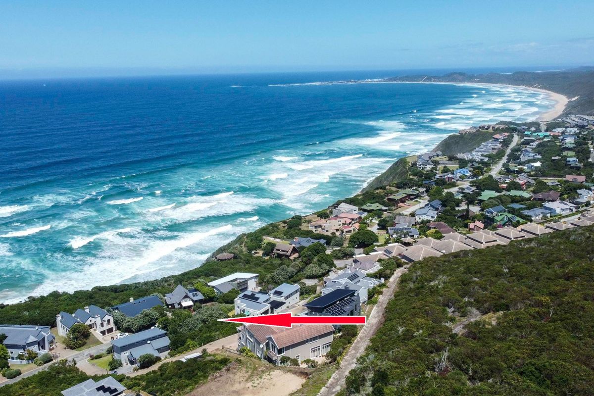 An aerial view of a coastal residential estate overlooking the ocean, highlighting the property location and surrounding landscape.