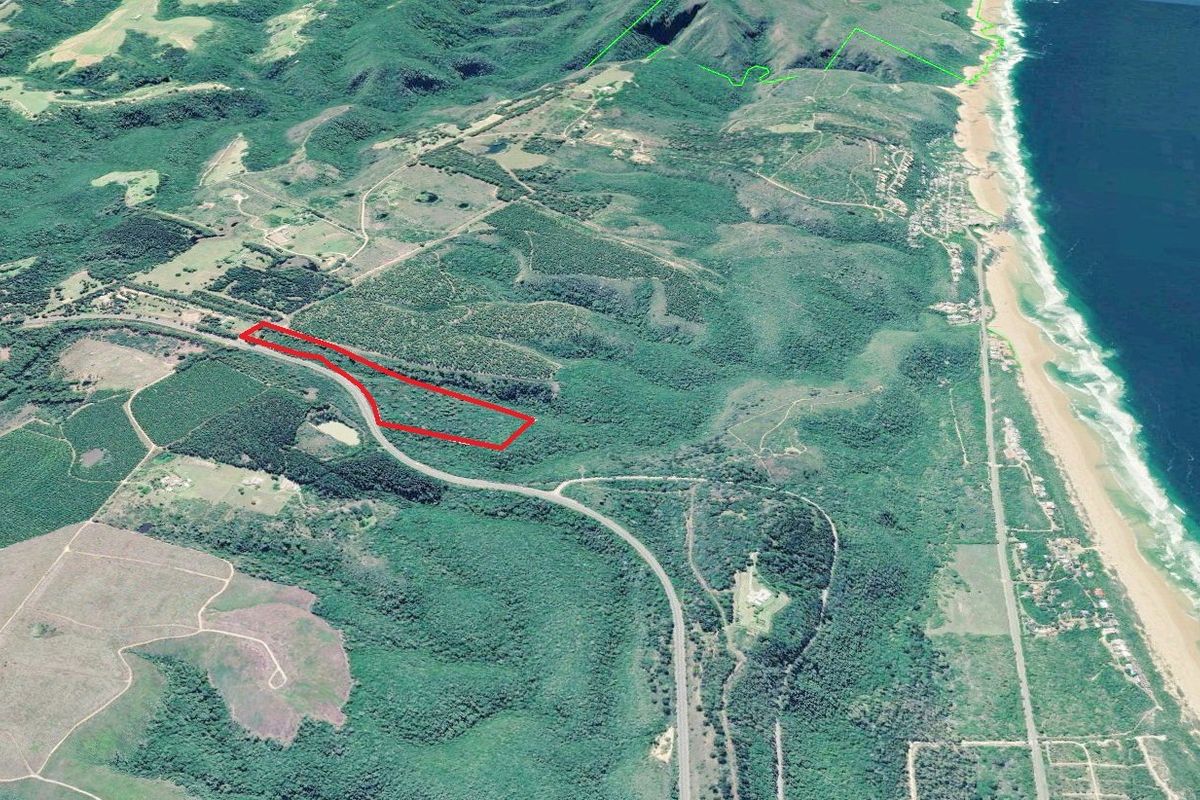 An aerial view of a large coastal farm property, highlighting the land boundaries and proximity to the coastline and surrounding natural landscape.
