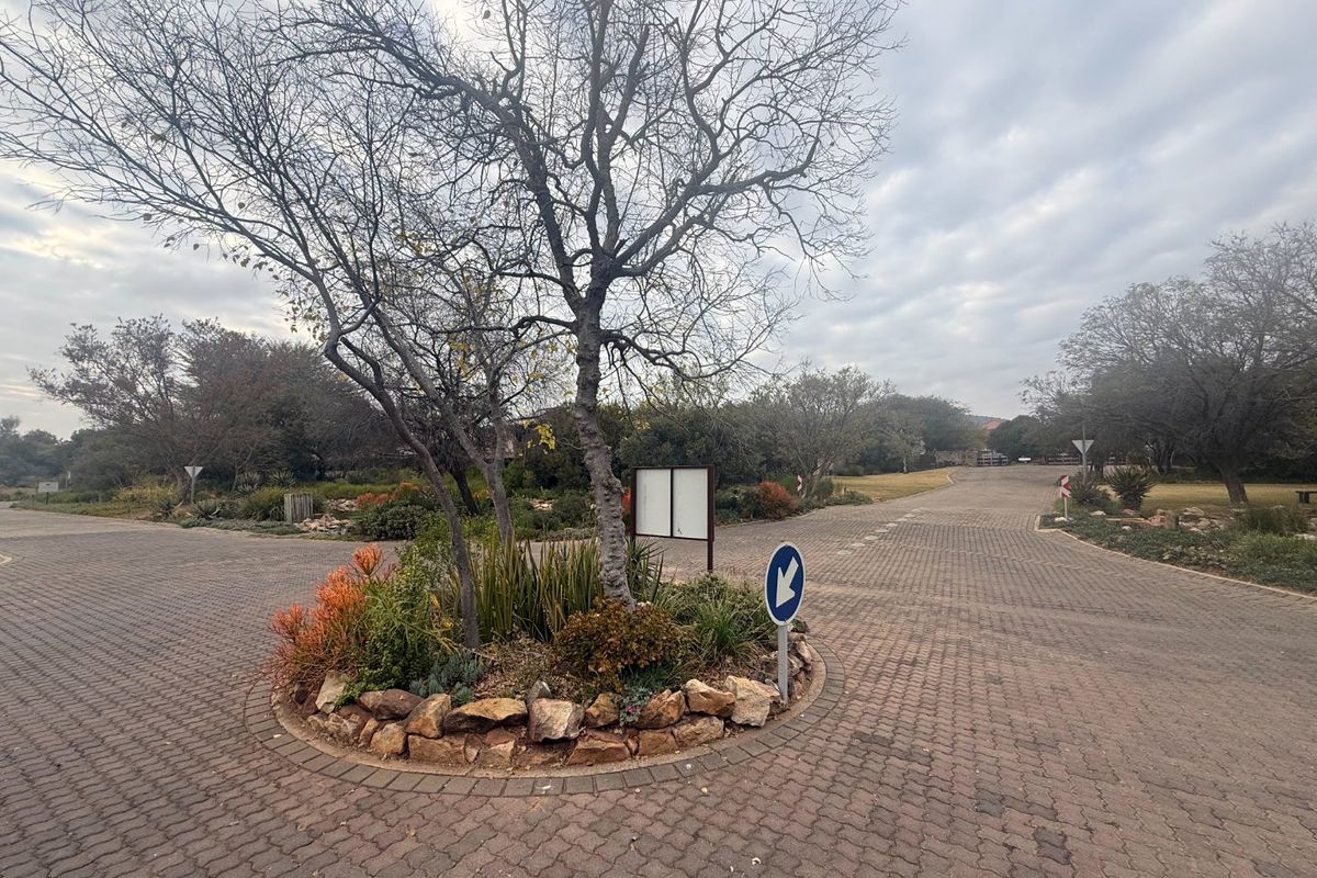 A view of the paved residential street and landscaped traffic island within the estate.
