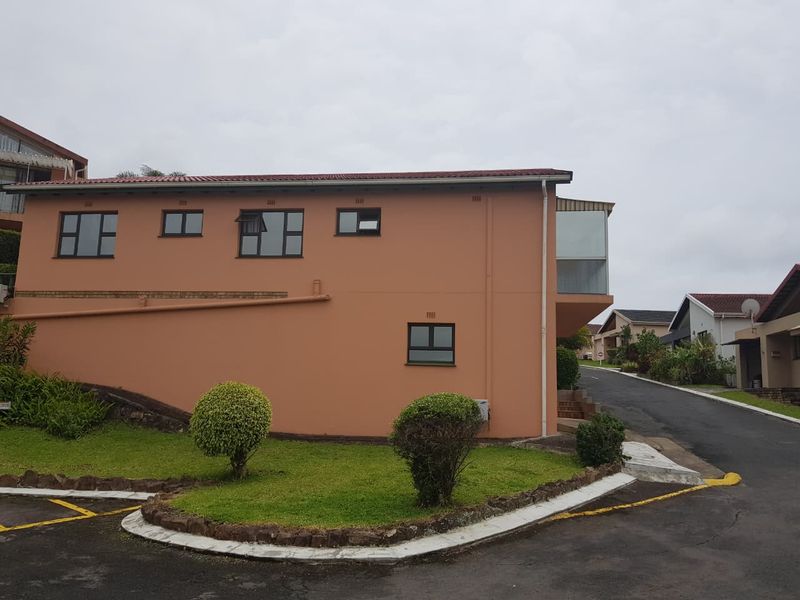 Side and rear elevation of a townhouse featuring a tiled roof, aluminium window frames, and an enclosed balcony area.