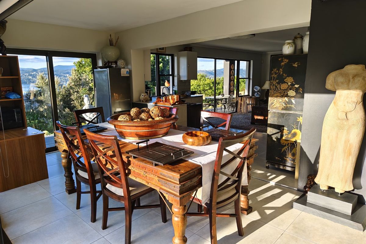 Spacious open-plan dining and kitchen area featuring large sliding glass doors that provide abundant natural light and scenic views.