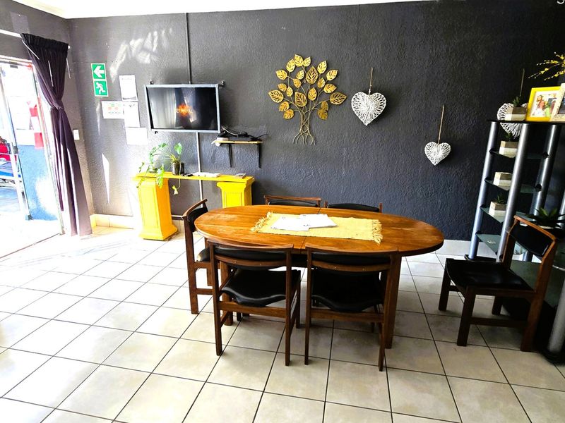 Dining area featuring tiled flooring and a sliding glass door providing access to the exterior.