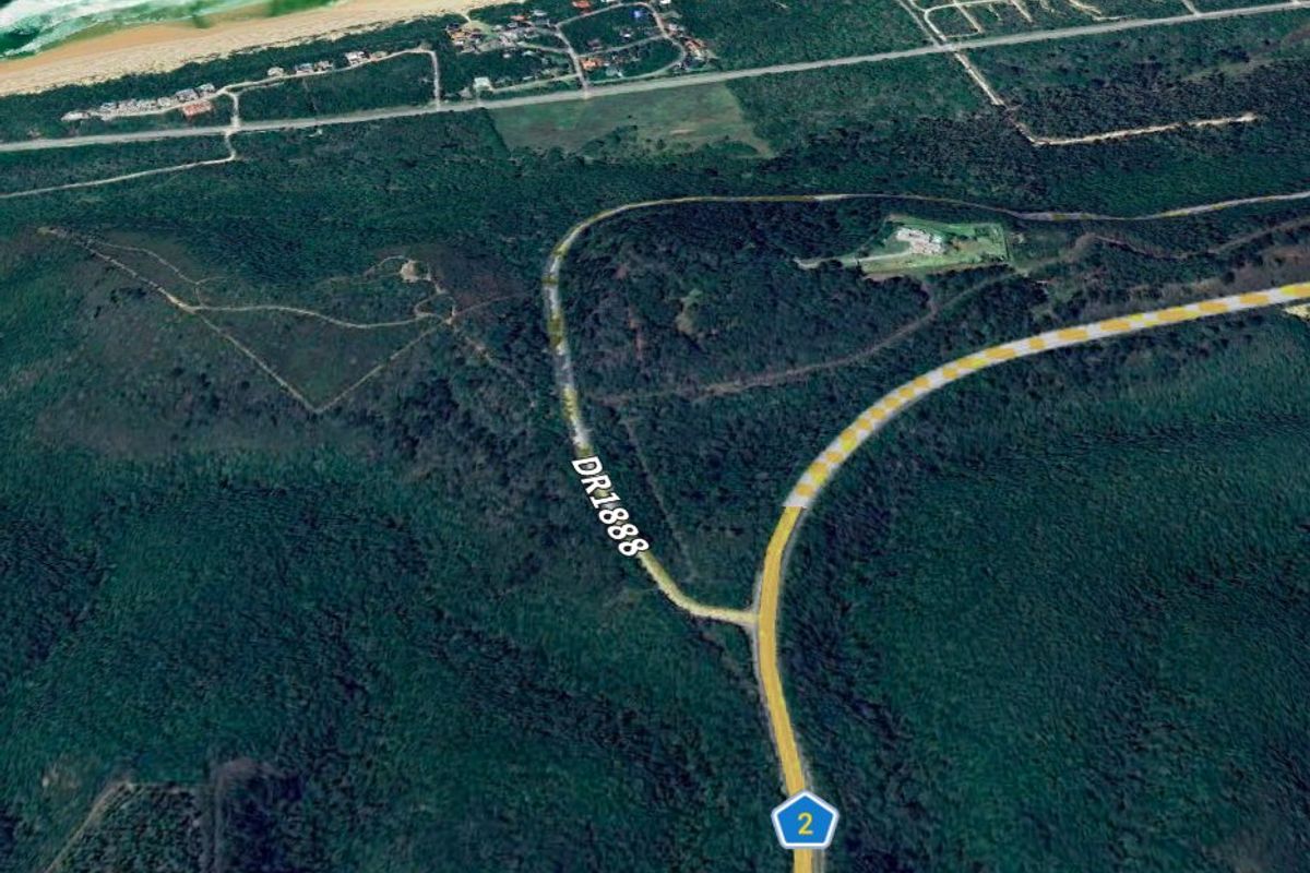 An aerial satellite view showing the location of an 11-hectare property in Plettenberg Bay, highlighting the surrounding landscape and proximity to the coastline.