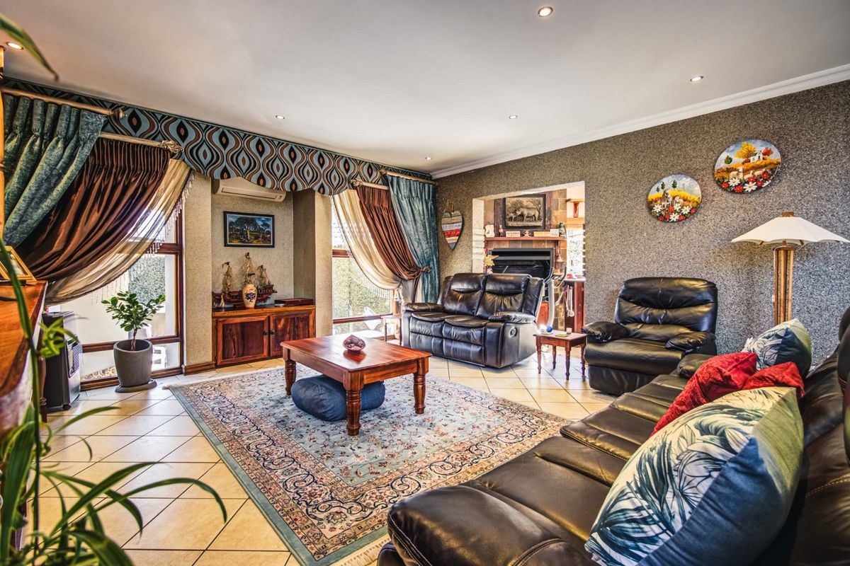 Spacious living room featuring tiled flooring, a built-in fireplace, split-system air conditioning, and textured wall finishes with recessed lighting.