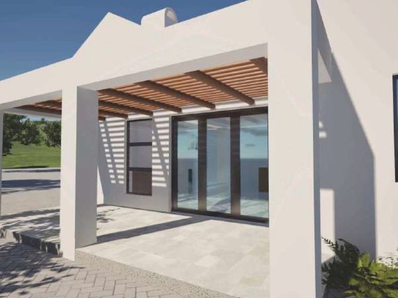 A modern covered patio featuring a timber pergola, concrete columns, and large sliding glass doors providing seamless indoor-outdoor flow.