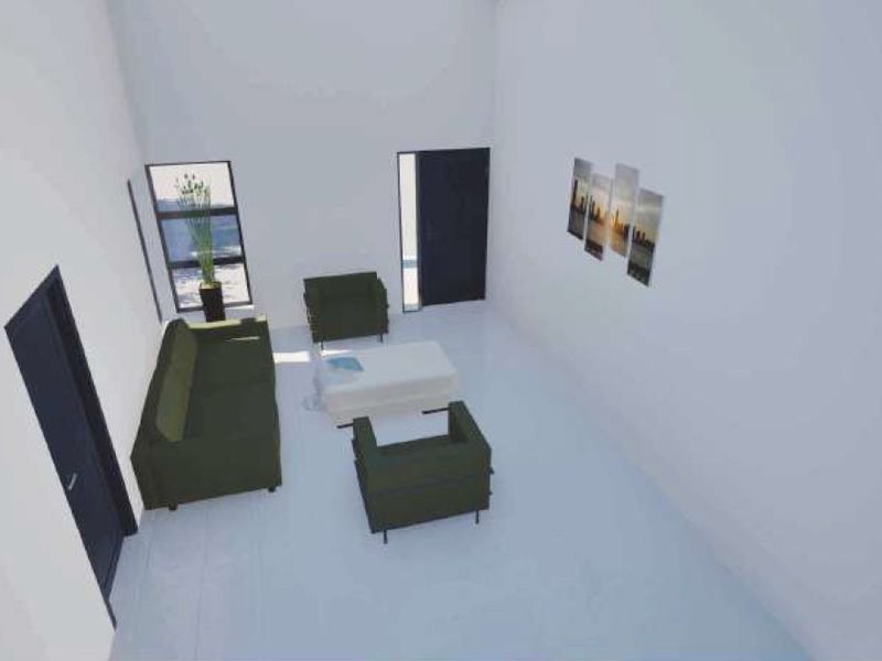 A high-angle view of a minimalist living room featuring plain white walls, dark doors, and large windows.