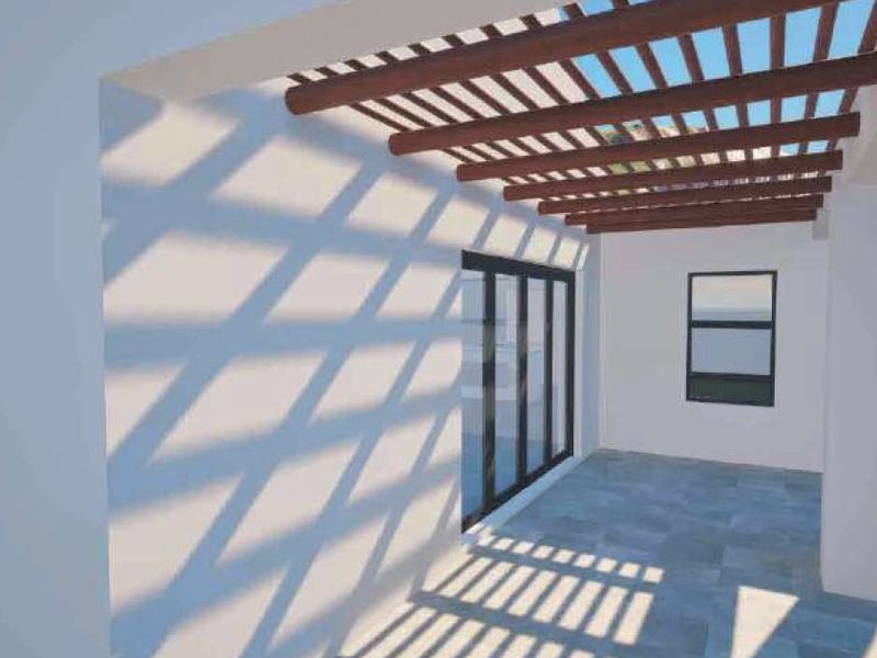 A covered patio area featuring a timber pergola, tiled flooring, and large sliding glass doors providing access to the interior.