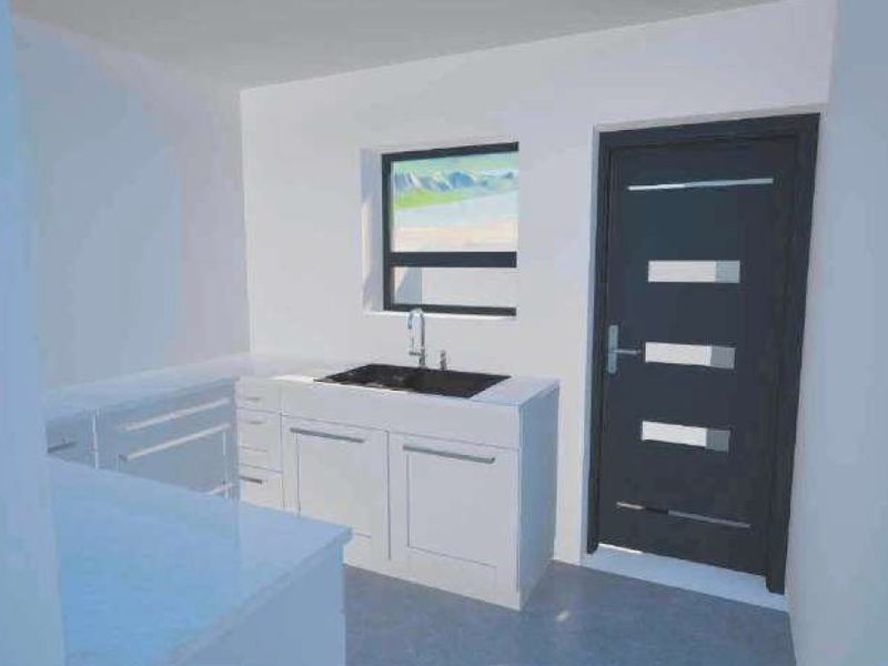 A minimalist kitchen area featuring white cabinetry, a sink, and a modern dark-toned exterior door.