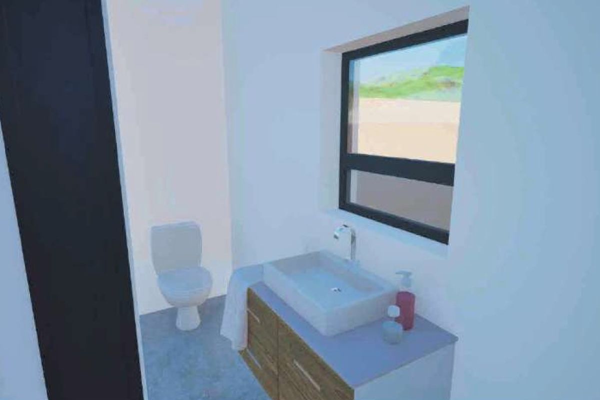 A modern bathroom featuring a vanity cabinet with a vessel sink, a toilet, and a window providing natural light.