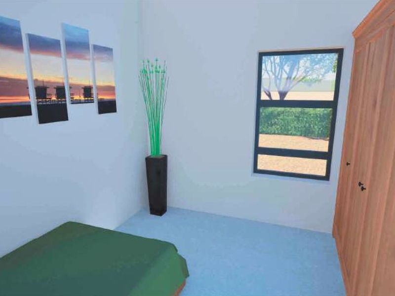A bedroom featuring a built-in wooden wardrobe and a window with an exterior view.