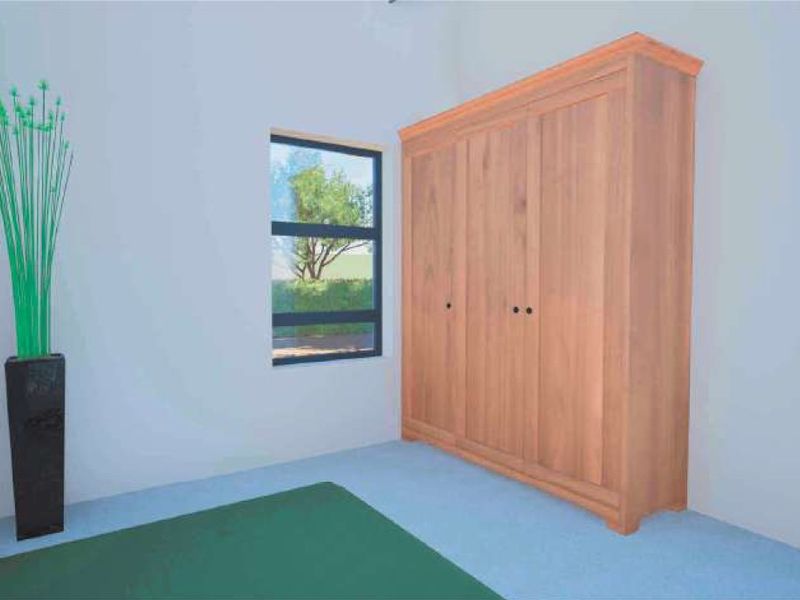 A bedroom featuring a built-in wooden wardrobe and a window with an aluminium frame.