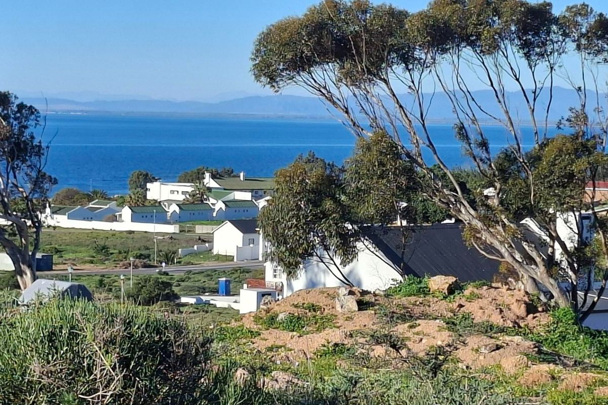 A scenic elevated view overlooking the coastal landscape and ocean, showcasing the surrounding residential area and natural terrain.