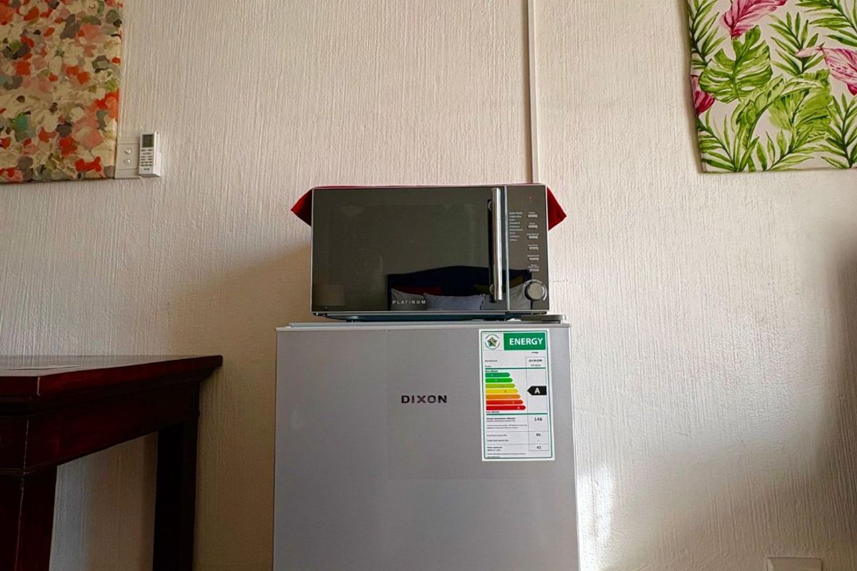 A living area featuring a wall-mounted air conditioning unit and standard electrical infrastructure.