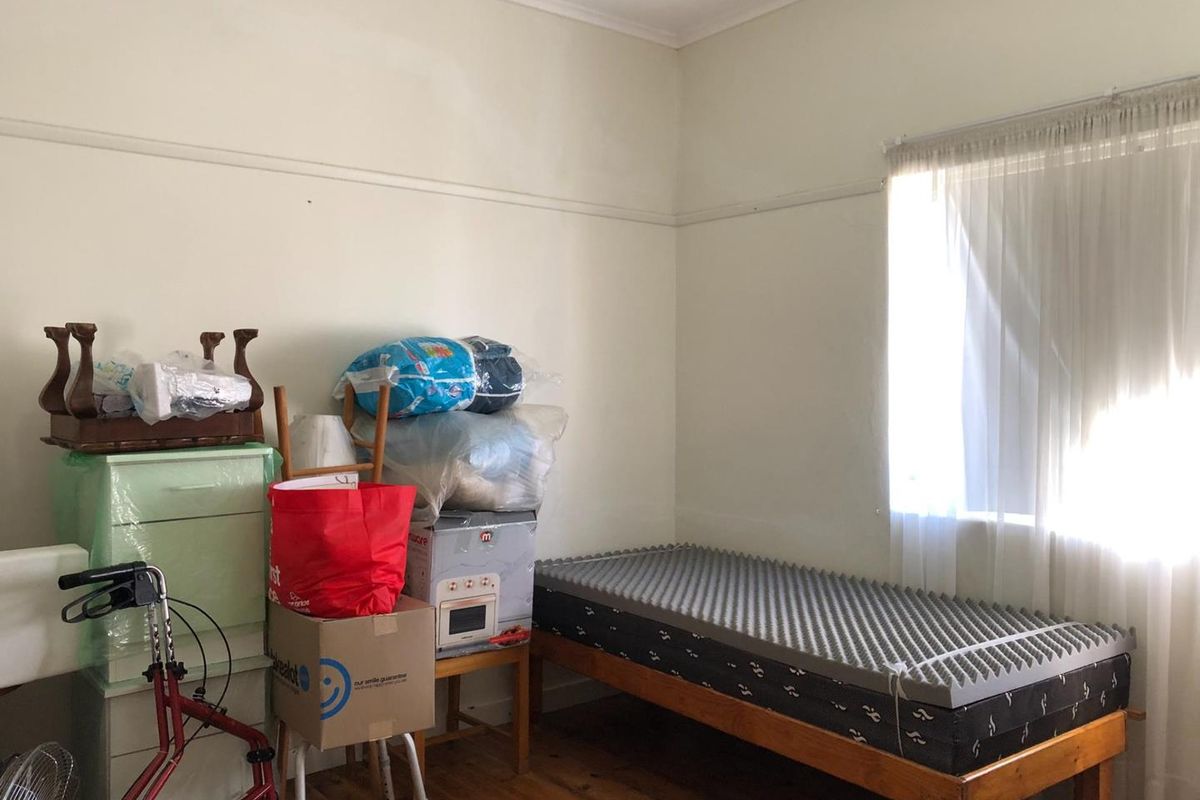 A bedroom featuring original timber flooring and a classic picture rail, offering a blank canvas for potential renovation or restyling.