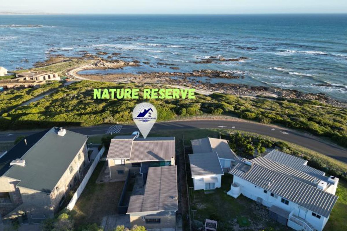 Aerial view of the property situated in a coastal location adjacent to a nature reserve.
