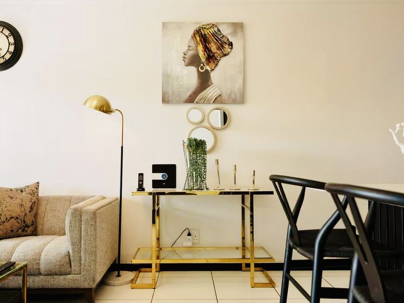 A well-maintained living area featuring neutral tiled flooring and clean wall finishes, providing a bright and inviting space.
