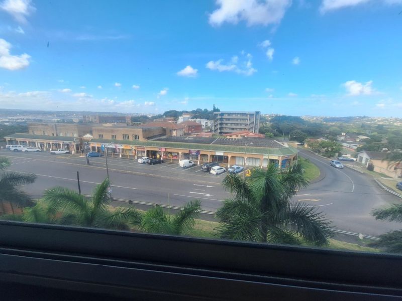 Elevated view overlooking a local commercial strip and surrounding neighbourhood infrastructure.